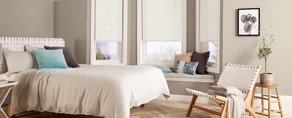 Cream sweet pea patterned roller blinds in bedroom