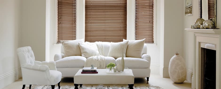 Dark wooden blinds in bay window