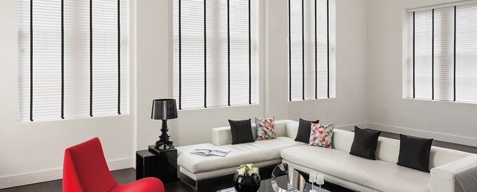 White faux wood blinds with black tapes in living room