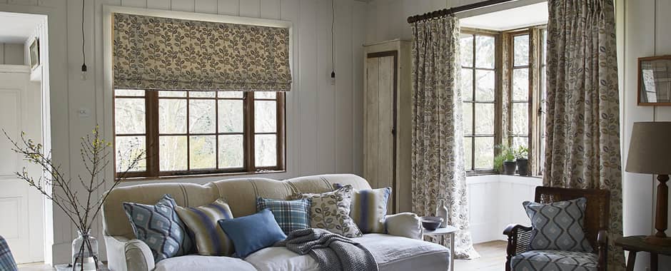 Leaf patterned roman blinds in cottage lounge