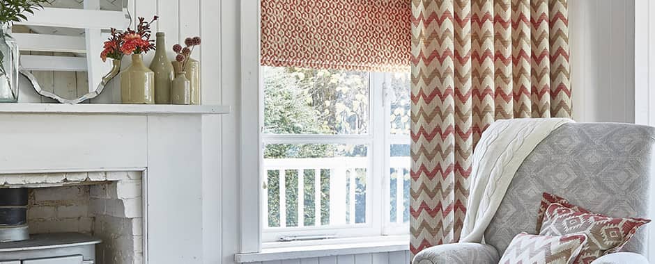 Red patterned roman blind in white living room