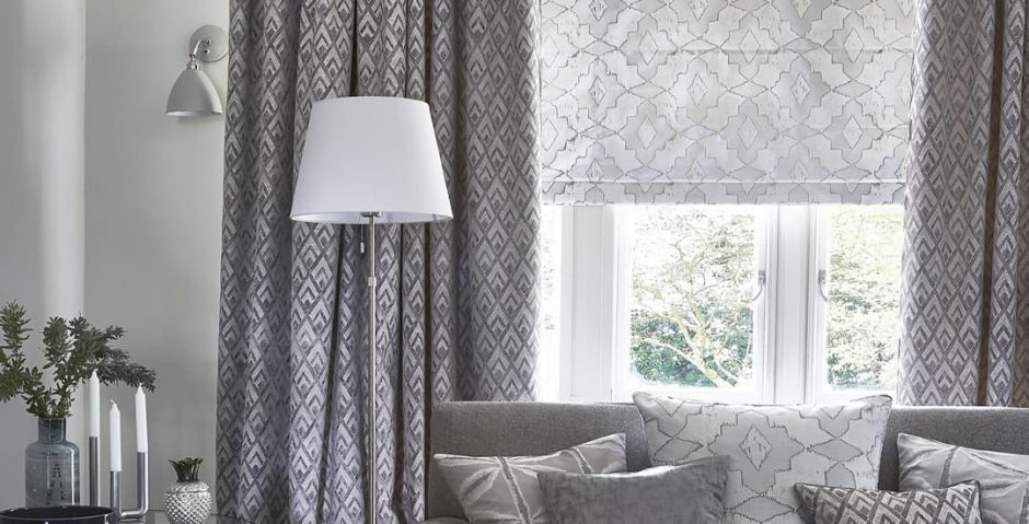 Are Roman Blinds Expensive Understanding The Cost Of Roman Blinds   Silver Patterned Roman Blinds In Lounge 940x479 