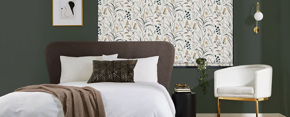 Floral patterned roller blinds closed at night in bedroom