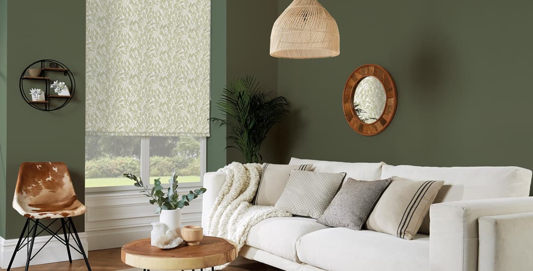 Green laurel leaves patterned roller blinds in living room