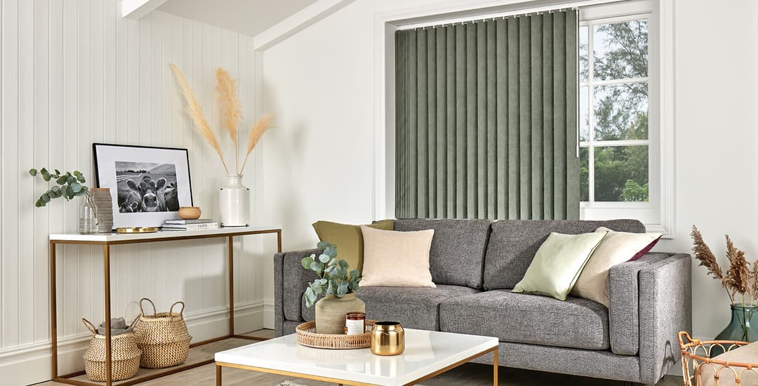 Green vertical blinds in living room