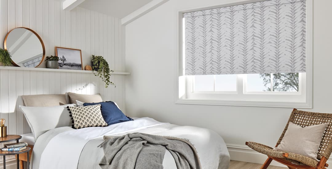 Grey acacia leaves patterned roller blinds in bedroom