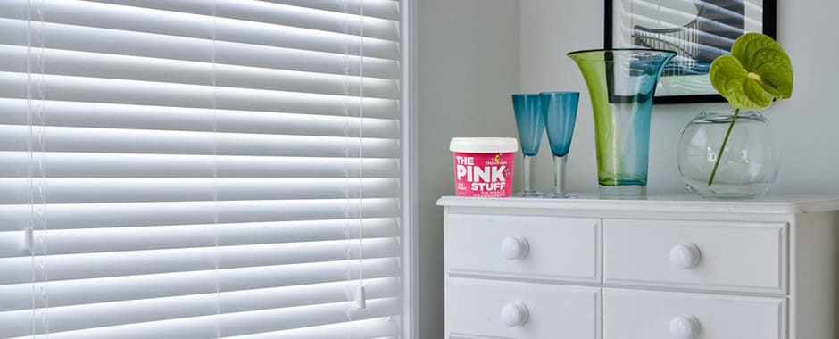 White wooden blinds with the pink stuff