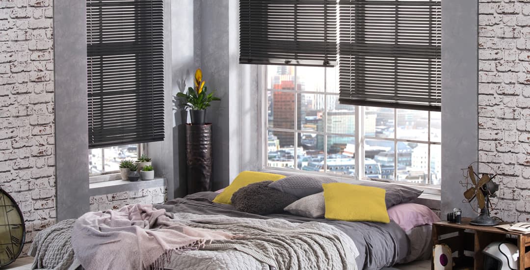 Dark grey aluminium venetian blinds in bedroom