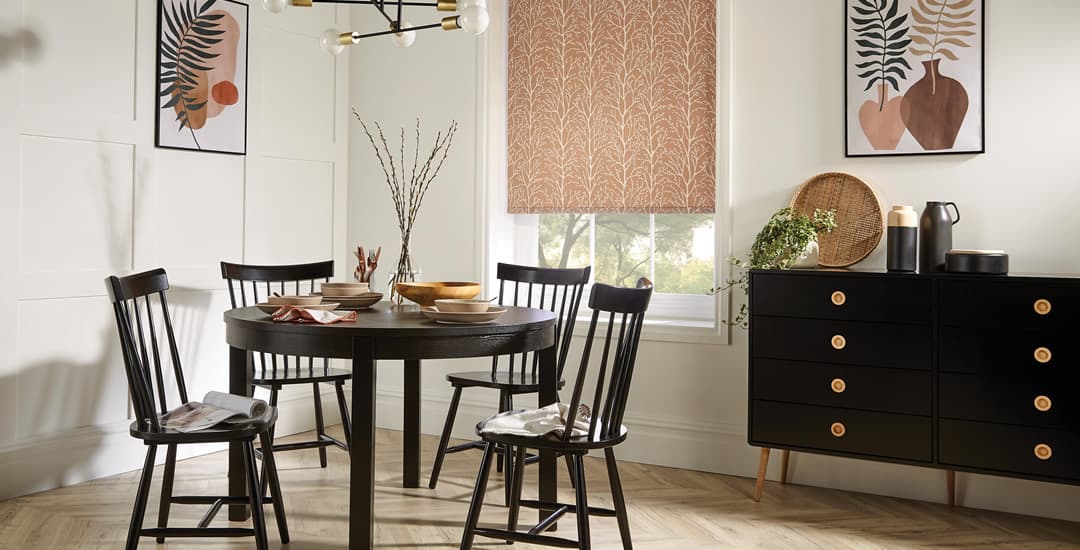 Metallic copper trees patterned roller blinds in black and white dining room