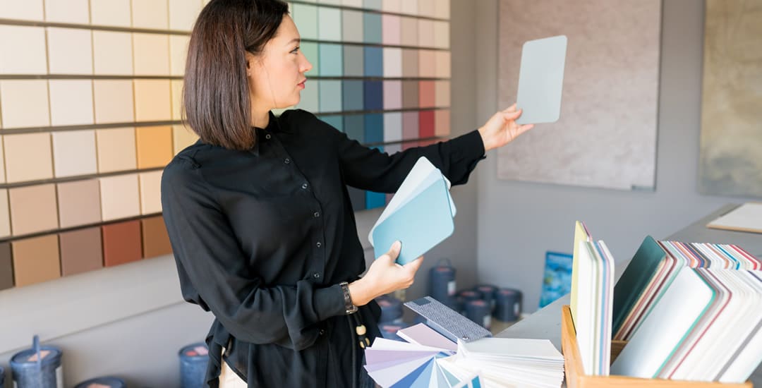 Woman choosing colour samples for home interior renovation