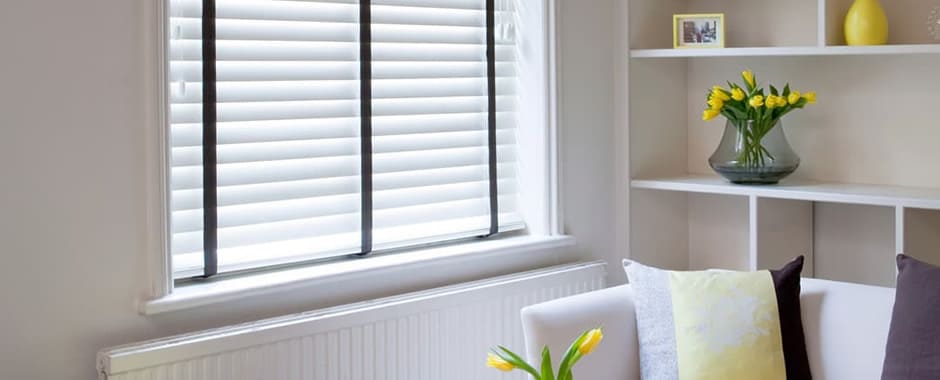 White faux wooden blinds black tapes living room