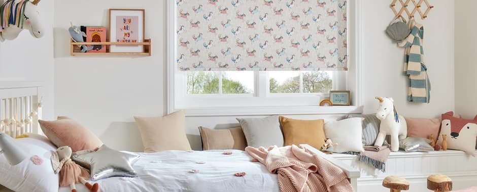 Unicorn patterned blackout roller blinds in children’s bedroom