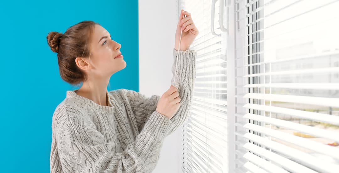 Woman operating blinds