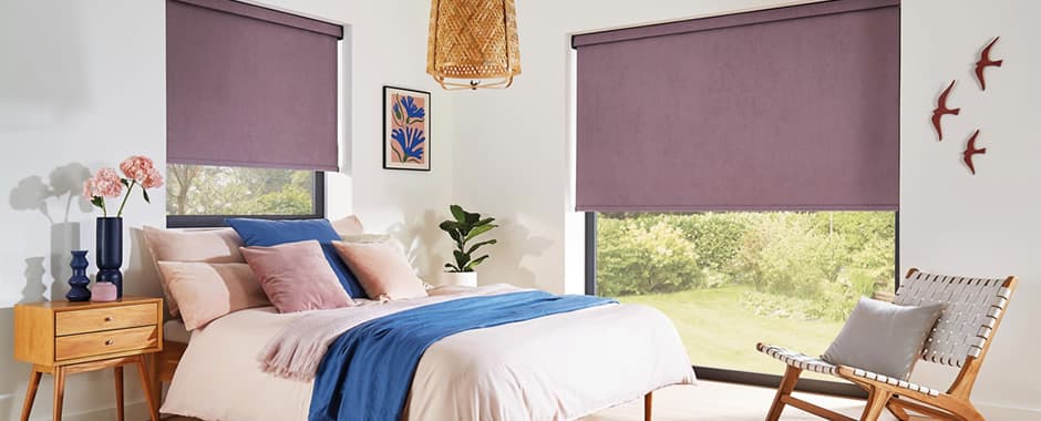 Purple blackout roller blinds in bedroom