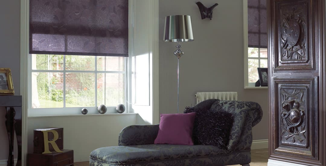 Purple patterned roller blinds in traditional wood panelled room