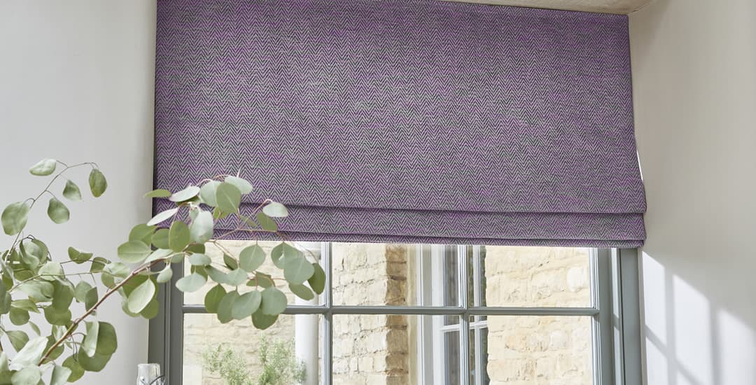 Purple roman blind in window