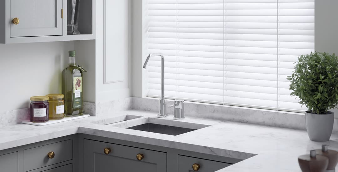 High quality white PVC faux wood blinds in grey kitchen