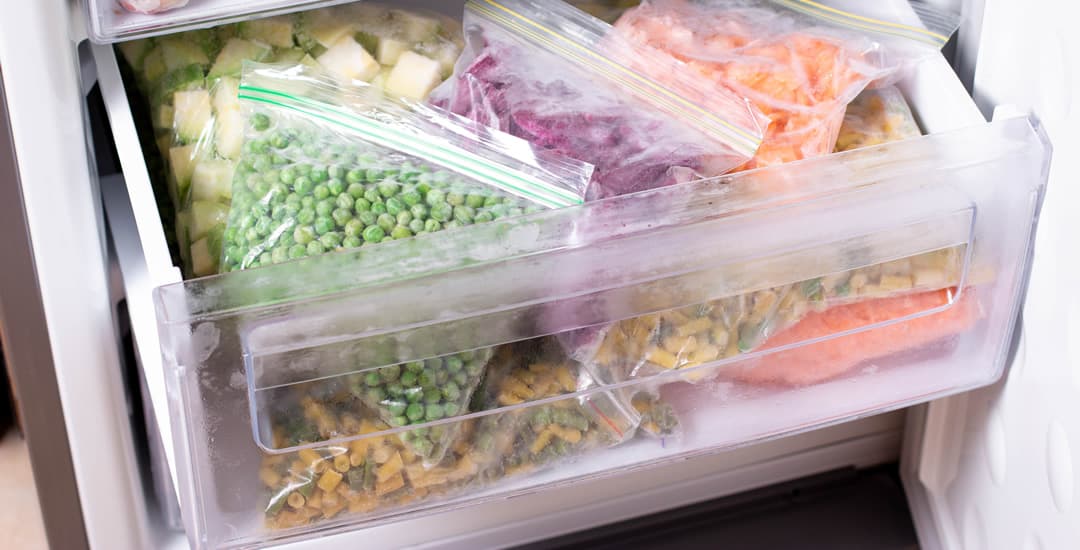 Bags of frozen vegetables in the freezer