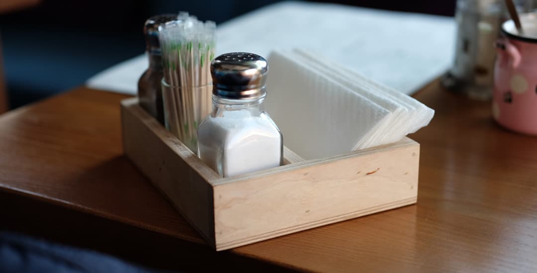 Serviettes, salt, pepper and toothpicks on a restaurant table