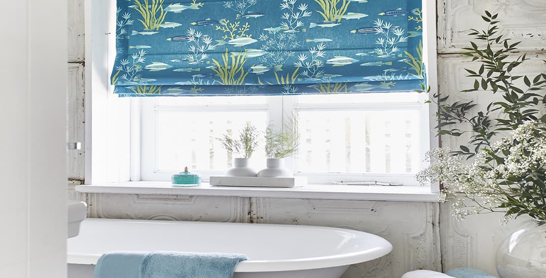 Blue fish patterned fabric roman blinds in bathroom