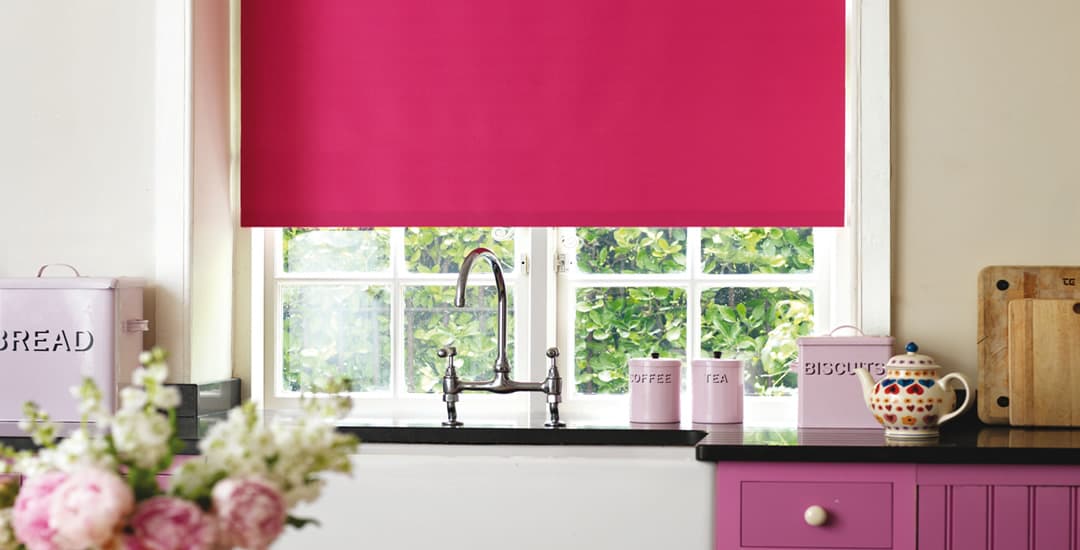 Colourful waterproof vinyl roller blinds above a kitchen sink