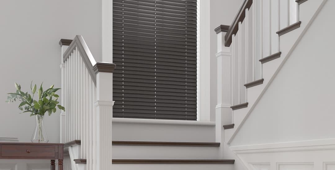 Dark wooden venetian blinds on staircase