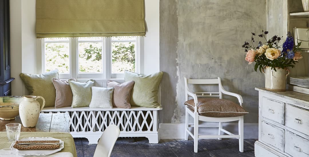 Luxury gold roman blinds in traditional dining room