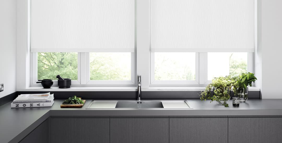 White pvc waterproof roller blinds above a kitchen sink